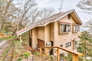 a house in the woods with a porch at NASU Fir Tree in Nasu