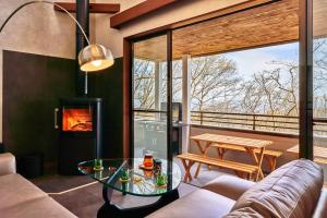 a living room with a couch and a fireplace at NASU Fir Tree in Nasu