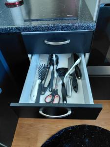 a drawer with scissors and other kitchen utensils at Apartment Kivistö, 2 km from centrum, free wifi and parking, no smoking, non-allergenic in Jyväskylä
