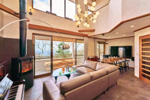 a living room with a couch and a fireplace at NASU Fir Tree in Nasu