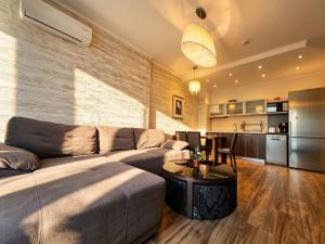 a living room with a couch and a table at Europroperties Golden Line in Golden Sands