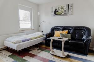 a living room with a couch and a table at Ferienwohnung Münch mit Balkon in Großheubach