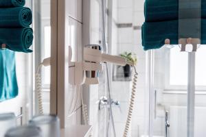 a white faucet in a bathroom next to a mirror at Ferienwohnung Münch mit Balkon in Großheubach +11 photos
