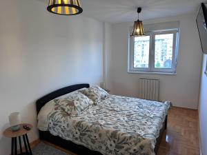 a bedroom with a bed and a window at Residence 16 in Belgrade