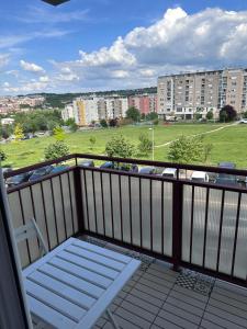 a balcony with a bench and a view of a field at Residence 16 in Belgrade
