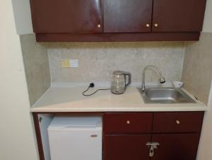 a kitchen counter with a sink and a mixer at Elevate suite Hotel time square kl in Kuala Lumpur
