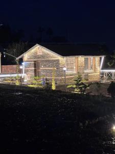 a stone house at night with lights on it at The Hideaway Chail in Chail