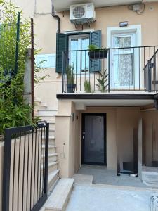 a building with a balcony and a door with plants at Almarè in Grottammare