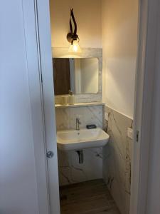 a bathroom with a sink and a mirror at Almarè in Grottammare +14 photos