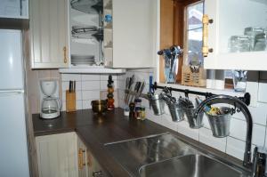 a kitchen with a sink and a counter top at Värmlandsstugan in Sälen +6 photos