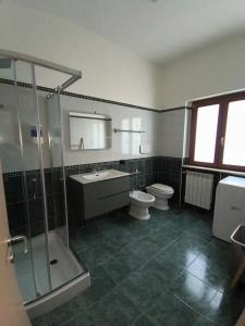 a bathroom with a toilet and a sink and a shower at Dimora Melania in San Nicola Arcella +15 photos