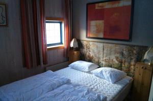 a bedroom with a bed with two pillows on it at Värmlandsstugan in Sälen