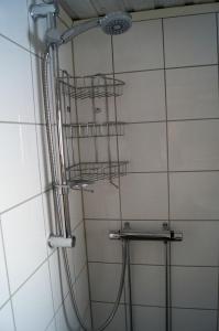 a shower in a bathroom with a shower head at Värmlandsstugan in Sälen