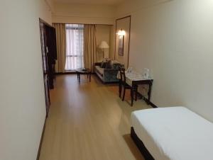 a hotel room with a bed and a living room at Elevate suite Hotel time square kl in Kuala Lumpur +51 photos