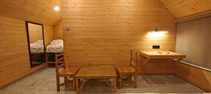 a wooden room with a table and a sink in it at Karibu Karjat Resort in Karjat