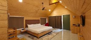 a bedroom with a bed in a wooden room at Karibu Karjat Resort in Karjat +17 photos