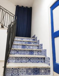 a staircase covered in blue and white tiles at B&B Spirito Santo in Casal Sottano