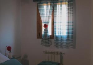 A bed or beds in a room at Apartamentos Rurales Azabal