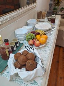a table topped with plates of food and fruit at Meerlin Guest House in Queenstown +4 photos