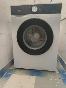 a white washing machine sitting in a bathroom at Travel Hub Hostel Social and Friendly in Ohrid