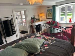 a bedroom with a bed with flowers on it at BeBaBopS Homestay Sønderborg in Sønderborg