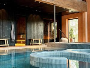 a swimming pool with blue water in a house at SÖRWESPA Nature Resort in Salme