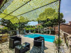 a swimming pool with chairs and a fence around it at L'Escapade Albigeoise in Albi