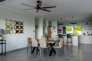 a kitchen and dining room with a table and chairs at Fairview Heights in Victoria