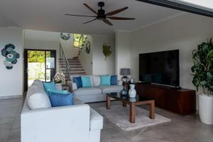 a living room with a white couch and a flat screen tv at Fairview Heights in Victoria