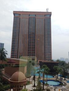 a tall building with a pool in front of it at Elevate suite Hotel time square kl in Kuala Lumpur