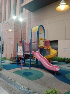 a playground with a slide in front of a building at Elevate suite Hotel time square kl in Kuala Lumpur