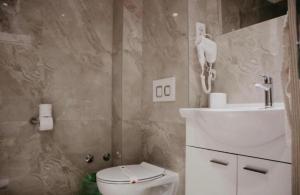 a bathroom with a toilet and a sink at Hotel Villa Matić in Neum +22 photos