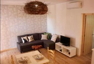 a living room with a couch and a table at Apartamentos Es Cupina in La Mola
