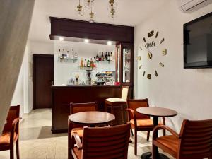 a restaurant with two tables and a bar at Melis Studios in Kallithea Halkidikis