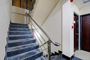 a set of stairs in a building with a door at Hotel O ASHIRBAD PALACE in Urāli