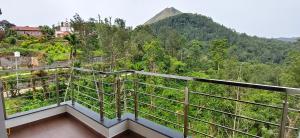 a balcony with a view of a mountain at Belmonte in Kalasa