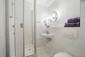 a bathroom with a shower and a toilet and a sink at Landpension Risch in Ilmenau +20 photos