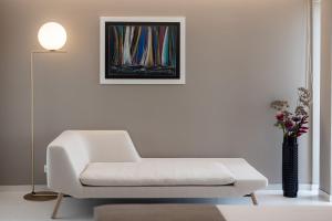a living room with a white couch and a vase of flowers at Hotel Joel in Novalja