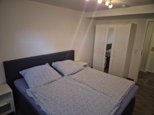 a bedroom with a bed with two pillows on it at Sonnenterrasse in Hörup