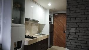 a kitchen with a sink and a counter top at Ruby Apartment #34 in Yogyakarta