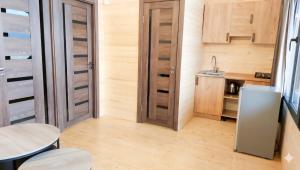 a small kitchen with a refrigerator and a table at Tsovazard Lake House in Tsovazard
