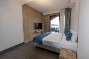 a hotel room with a bed and a television at Panoramic Konaklama Tesisi Bodrum in Bodrum City +68 photos