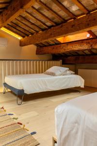 a bedroom with a bed and a wooden ceiling at Casa GenaRita in Ravenna