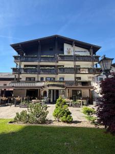 a large building with tables and chairs in front of it at Hotel Mesnerwirt - Zentrumslage in Westendorf +45 photos