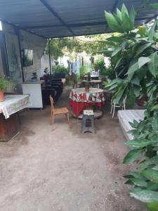 a patio with a table and chairs under a tent at Erdek Özlem pansiyon in Erdek +9 photos