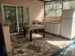 a kitchen with a table and a refrigerator at Erdek Özlem pansiyon in Erdek