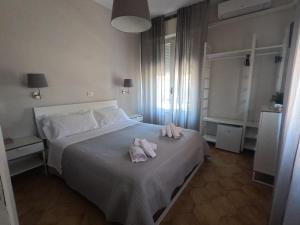 a bedroom with a bed with two towels on it at T Hotel- Adults Only, Pet Free Hotel in Rimini
