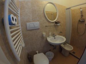 a bathroom with a sink and a toilet and a mirror at T Hotel- Adults Only, Pet Free Hotel in Rimini