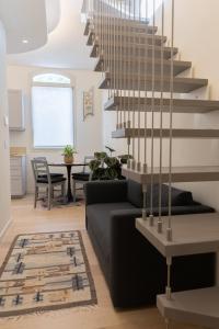 a living room with a staircase and a couch at Casa GenaRita in Ravenna