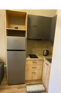 a small kitchen with a refrigerator and a stove at Kechi Dom 6 in Tsaghkadzor